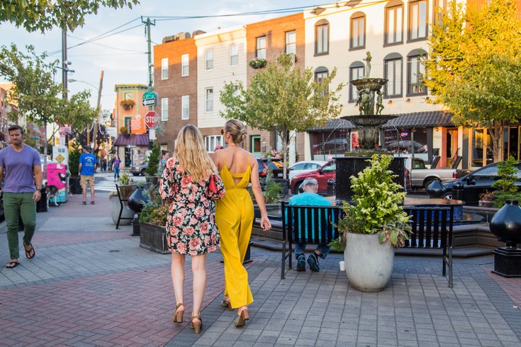 People stroll East Passyunk Avenue during Passyunk Passeggiata