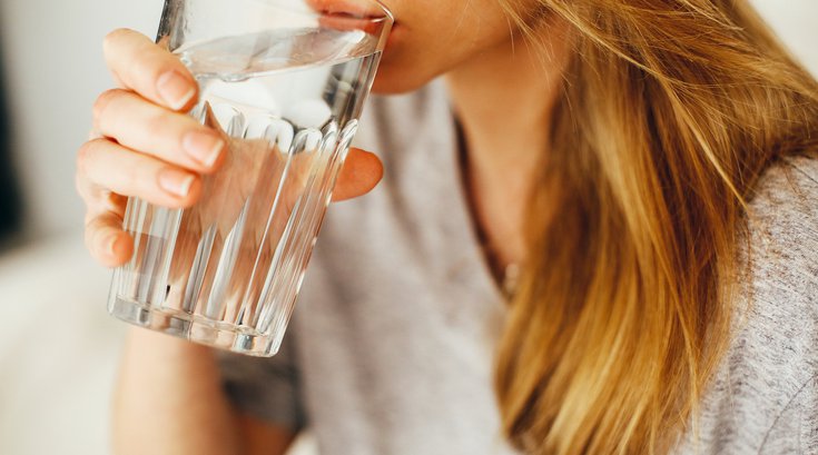 Woman drinking water from glass