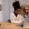 Mother and daughter looking at a website together