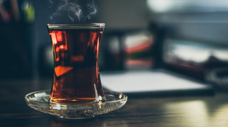 Black tea steaming on table