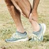 A man holding his leg in pain