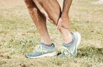 A man holding his leg in pain