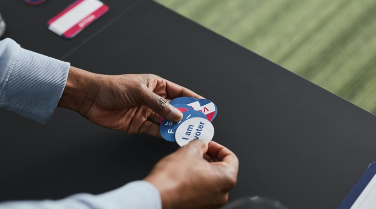 A Volunteer Working on Election Day with Stickers