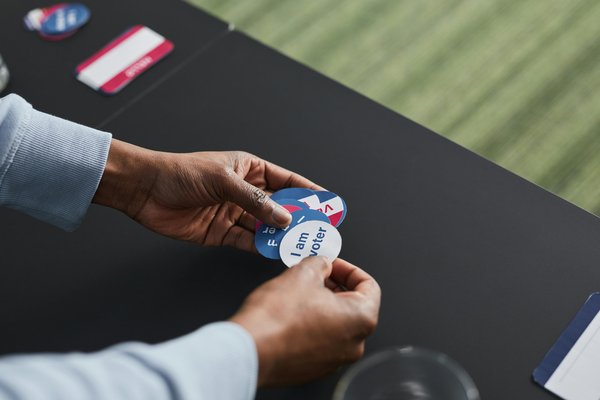 A Volunteer Working on Election Day with Stickers