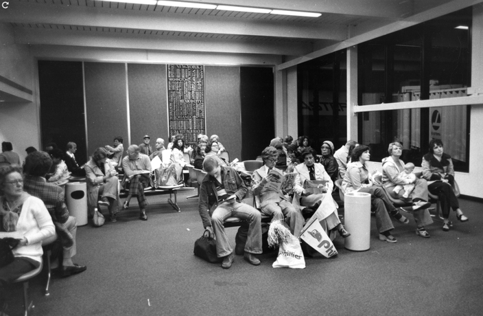 Black-and-white photo of Phillies fans waiting in airport terminal