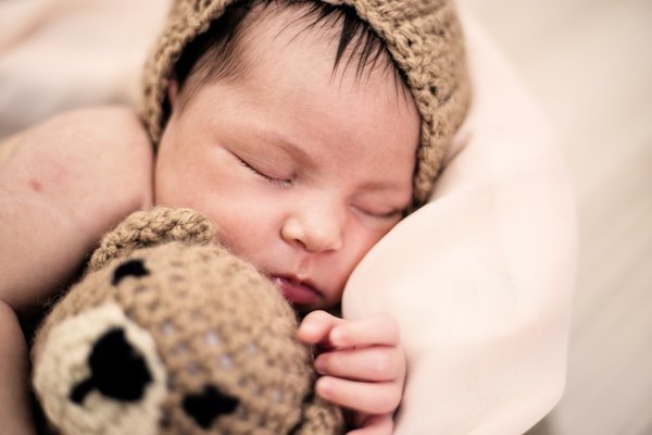 Sleeping baby with stuffed animal