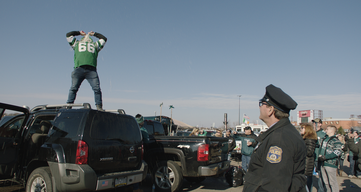 Fans drink in the parking lot at the Linc, as shown in 