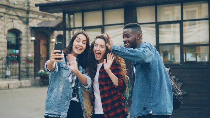 Three friends snapping a selfie while traveling together