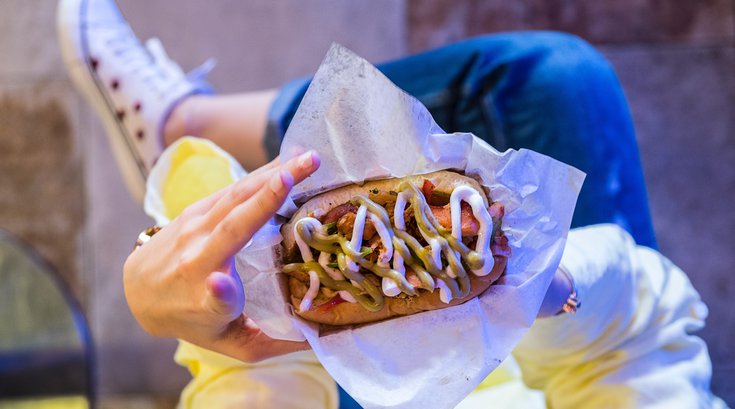 woman with fast food in hand