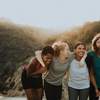 Women hiking with sunset in background